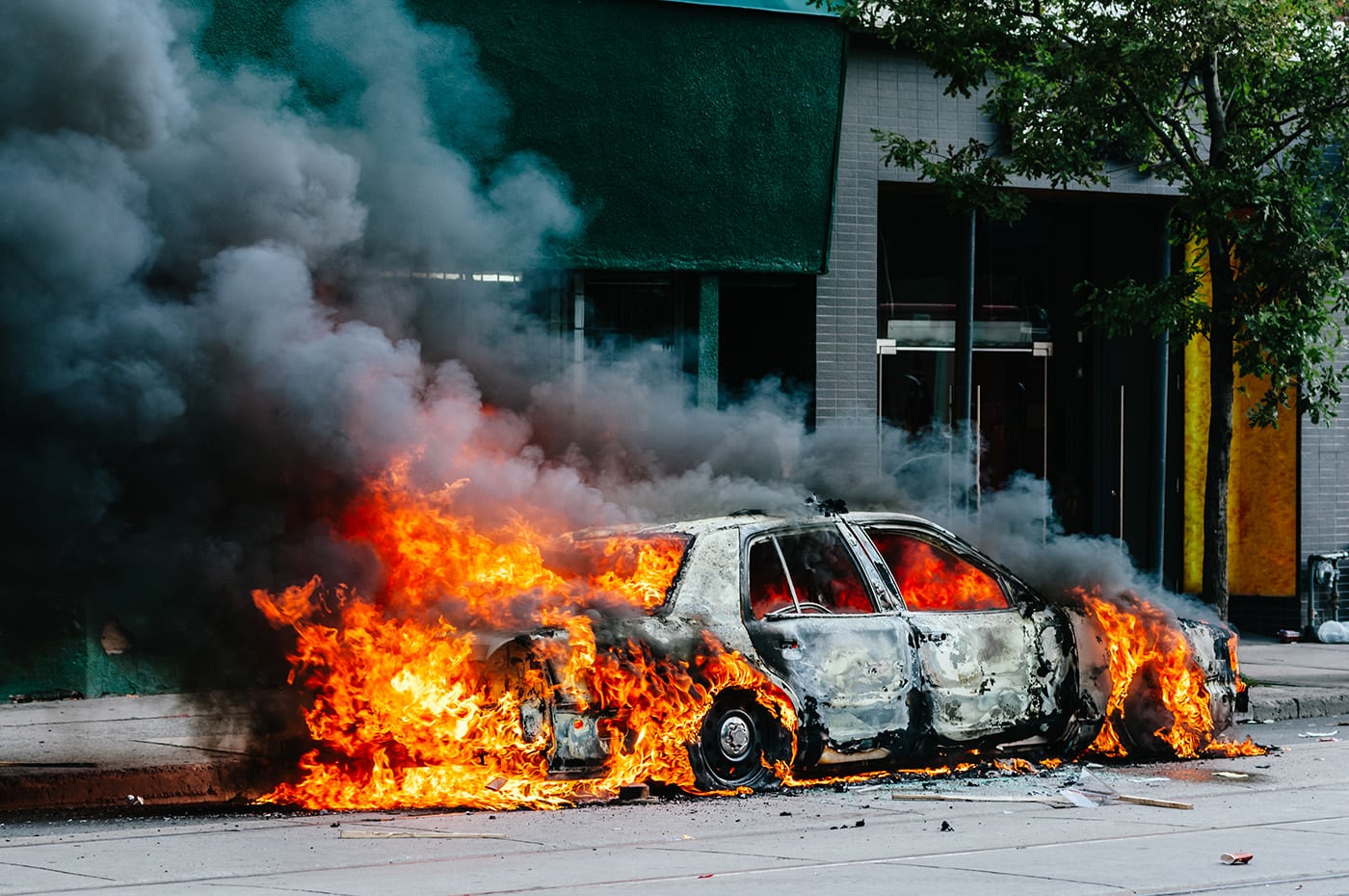 A police car was lit on fire during a protest in Toronto, Canada. Here the fire is still burning but the vehicle is no longer recognizable.