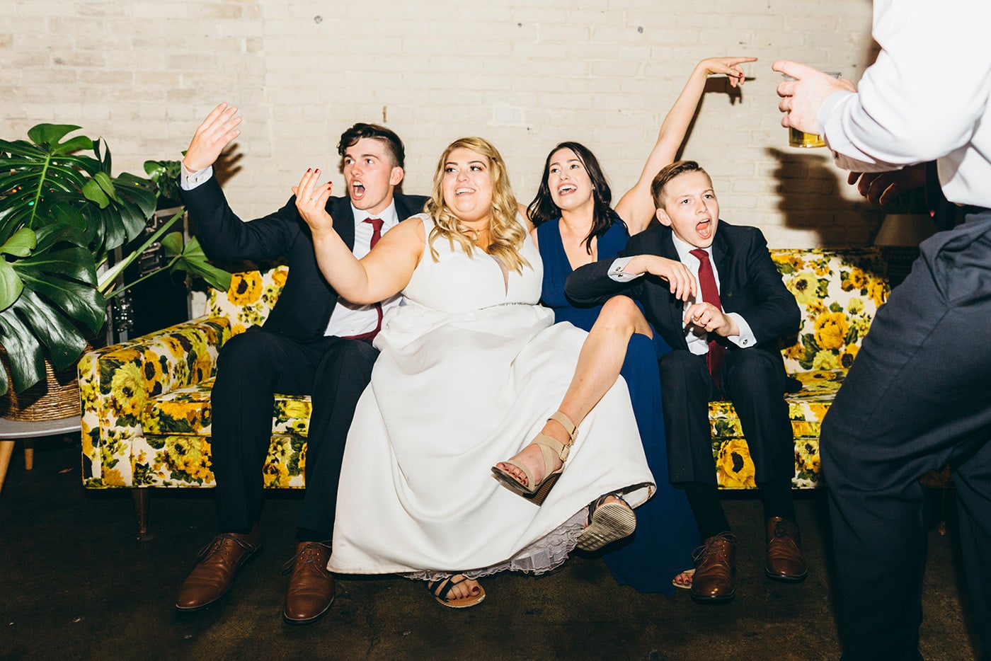 Funny, Lifestyle Photo Of Bride With Her Siblings At Wedding Reception