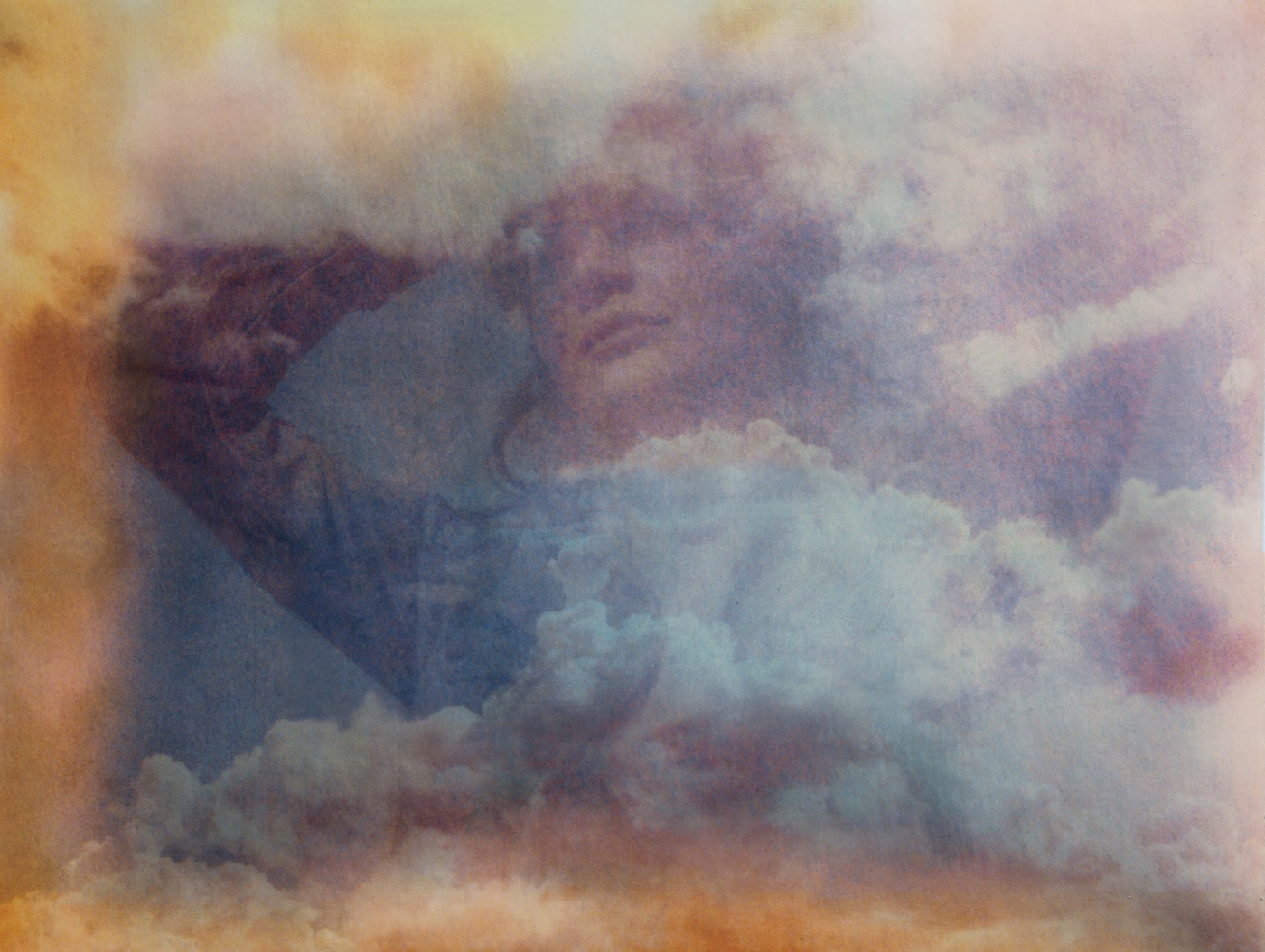 Outdoor portrait of a young woman- Double exposure on messed up Polaroid Film taken against the sky