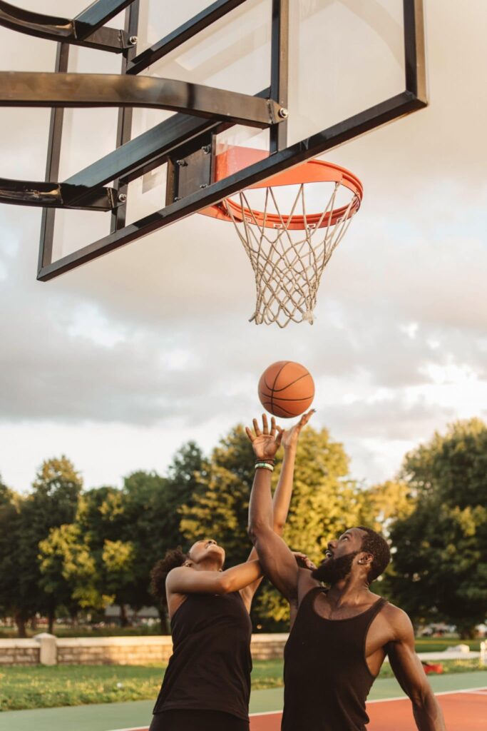 An Attractive African American Couple Playing Basketball On A Sunny Day