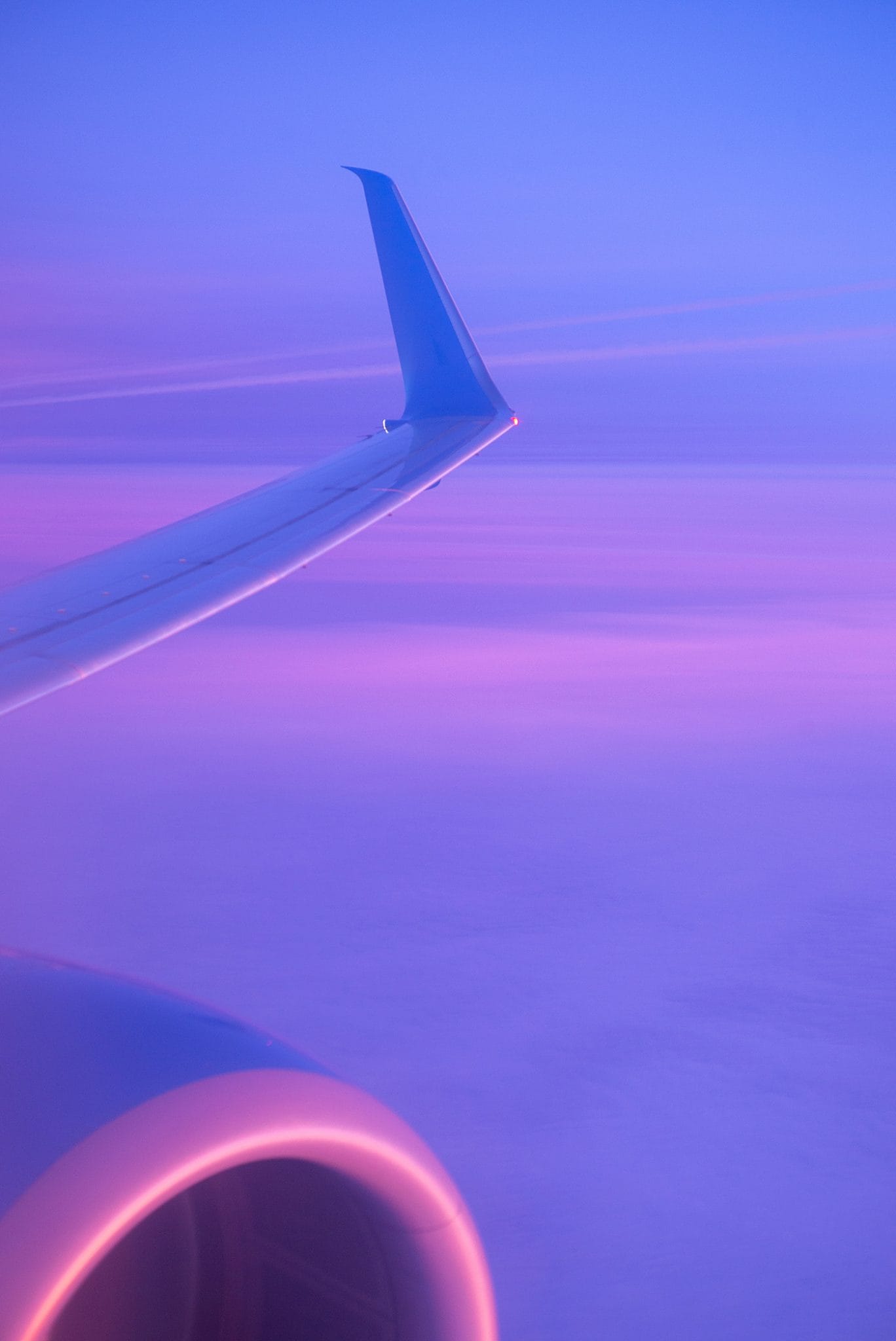 Wing Of Plane Flying In Twilight Mist