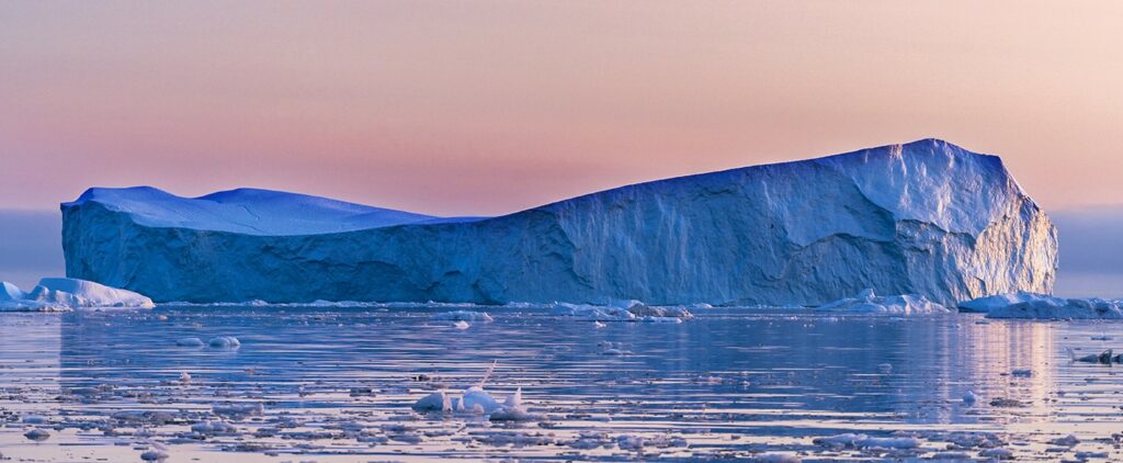 Icebergs In Midnight Sun In Greenland