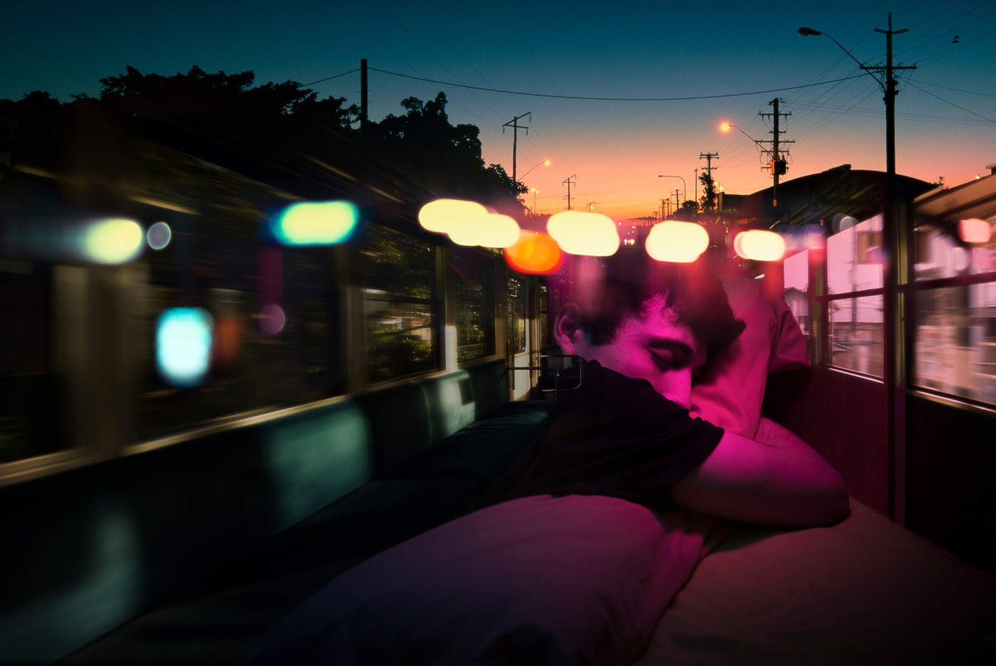 Double exposure portrait of a young teenage boy sleeping and having some mixed dreams all together where situations and colours appears at the same time