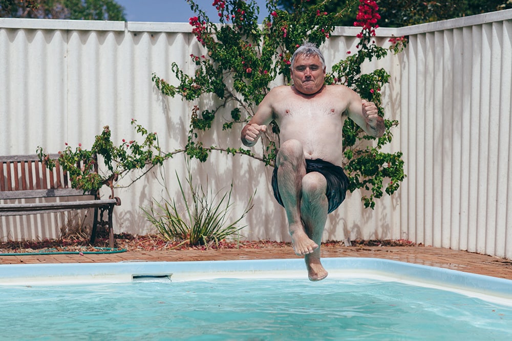 Retired Aged Man Jumps Into Backyard Swimming Pool