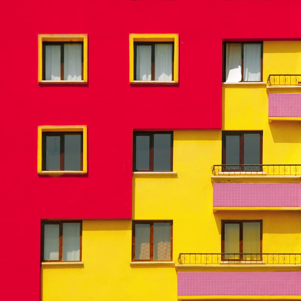 red yellow wall with pink balcony