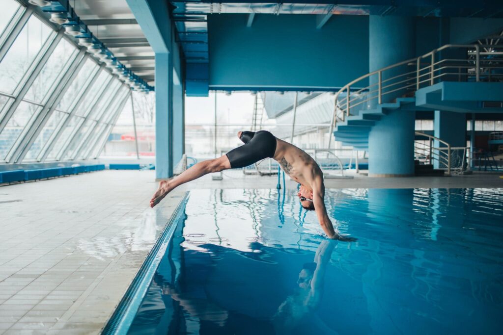 Young sportsman jumping in the pool