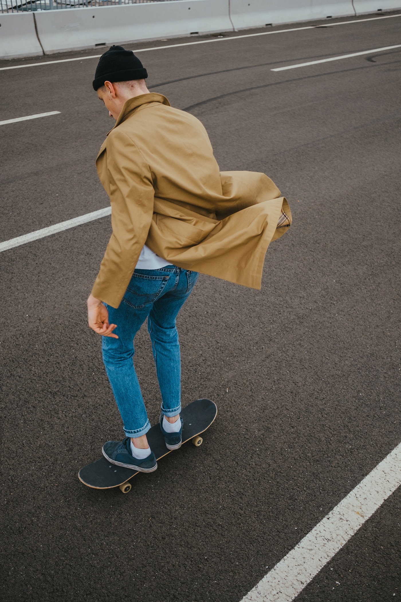 Young Authentic Urban Adolescent/Skateboarder On The Streets Doing Tricks.