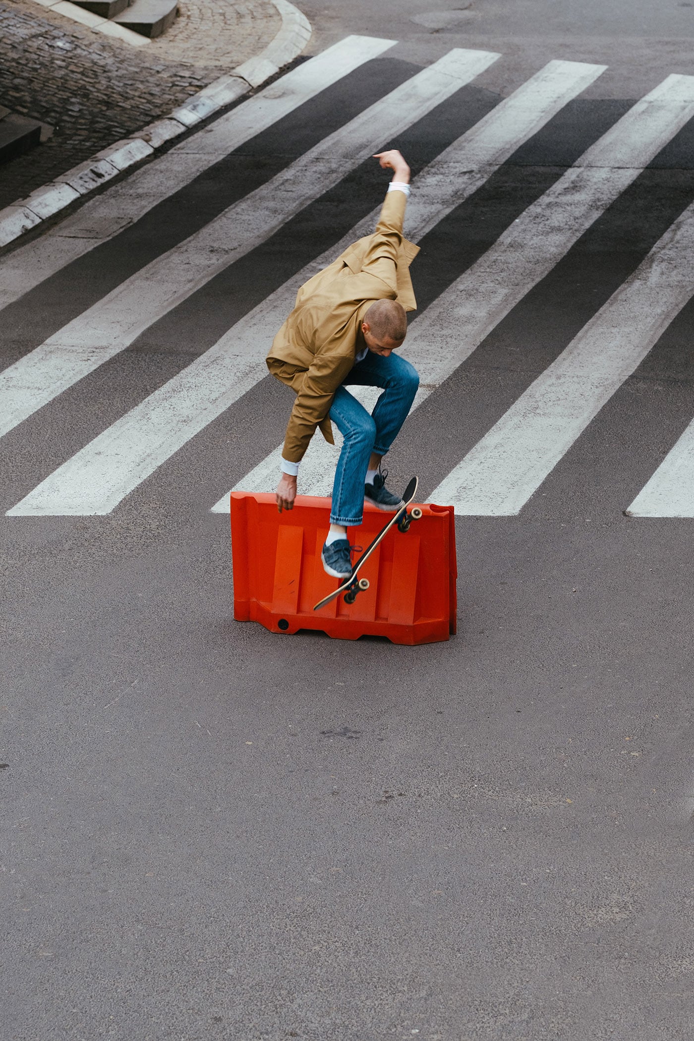 Young Authentic Urban Adolescent/Skateboarder On The Streets Doing Tricks.