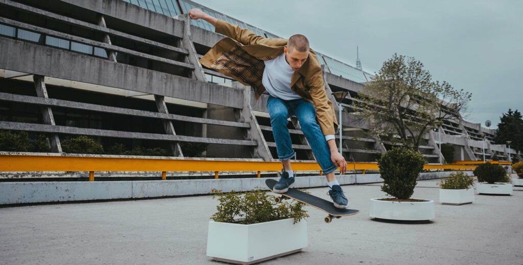 Young Authentic Urban Adolescent/Skateboarder On The Streets Doing Tricks.