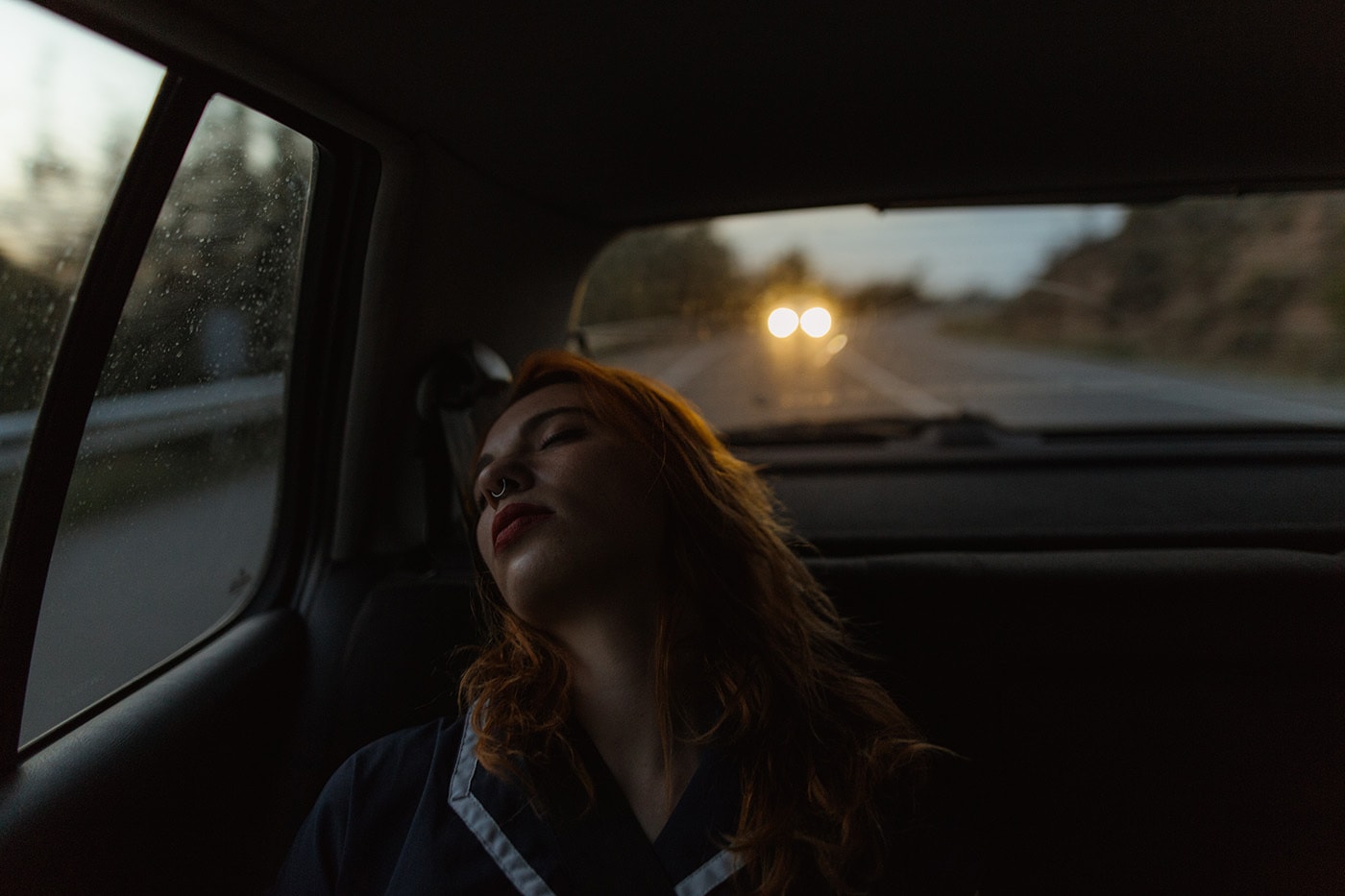 Ginger Woman Sleeping In A Car During A Road Trip
