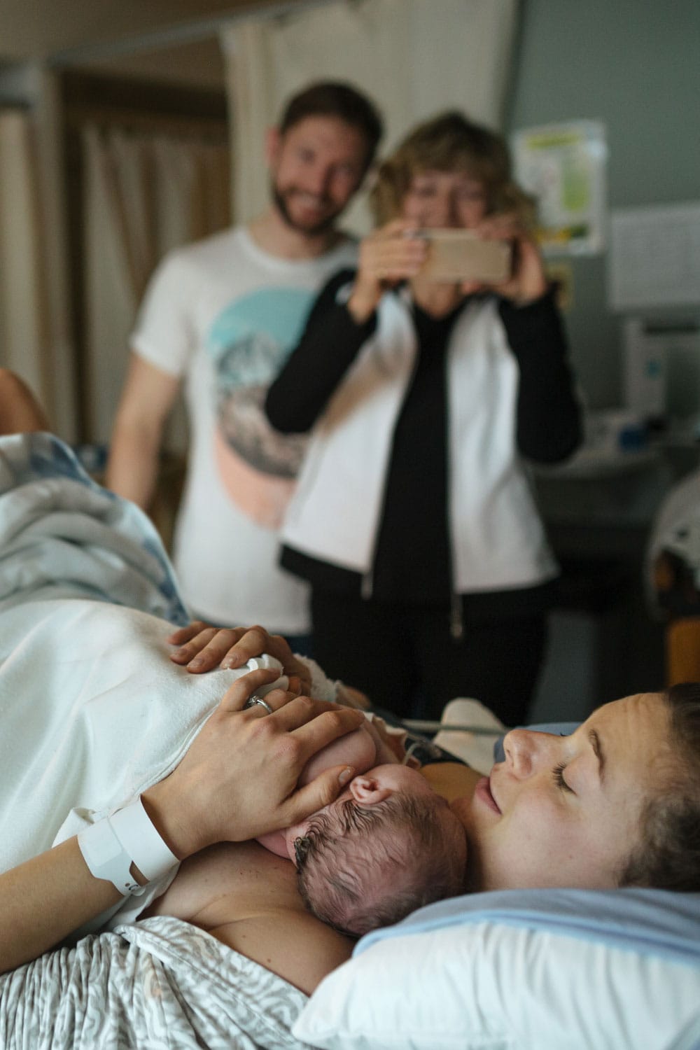 Brand New Mother, Father And Child After Delivery In Hospital Room
