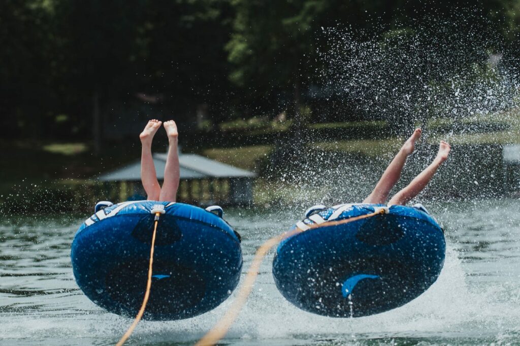 Kids having fun tubing at Norris lake while on vacation Boating