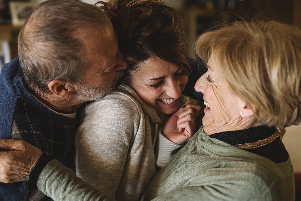 Happy woman with her parents having fun together.