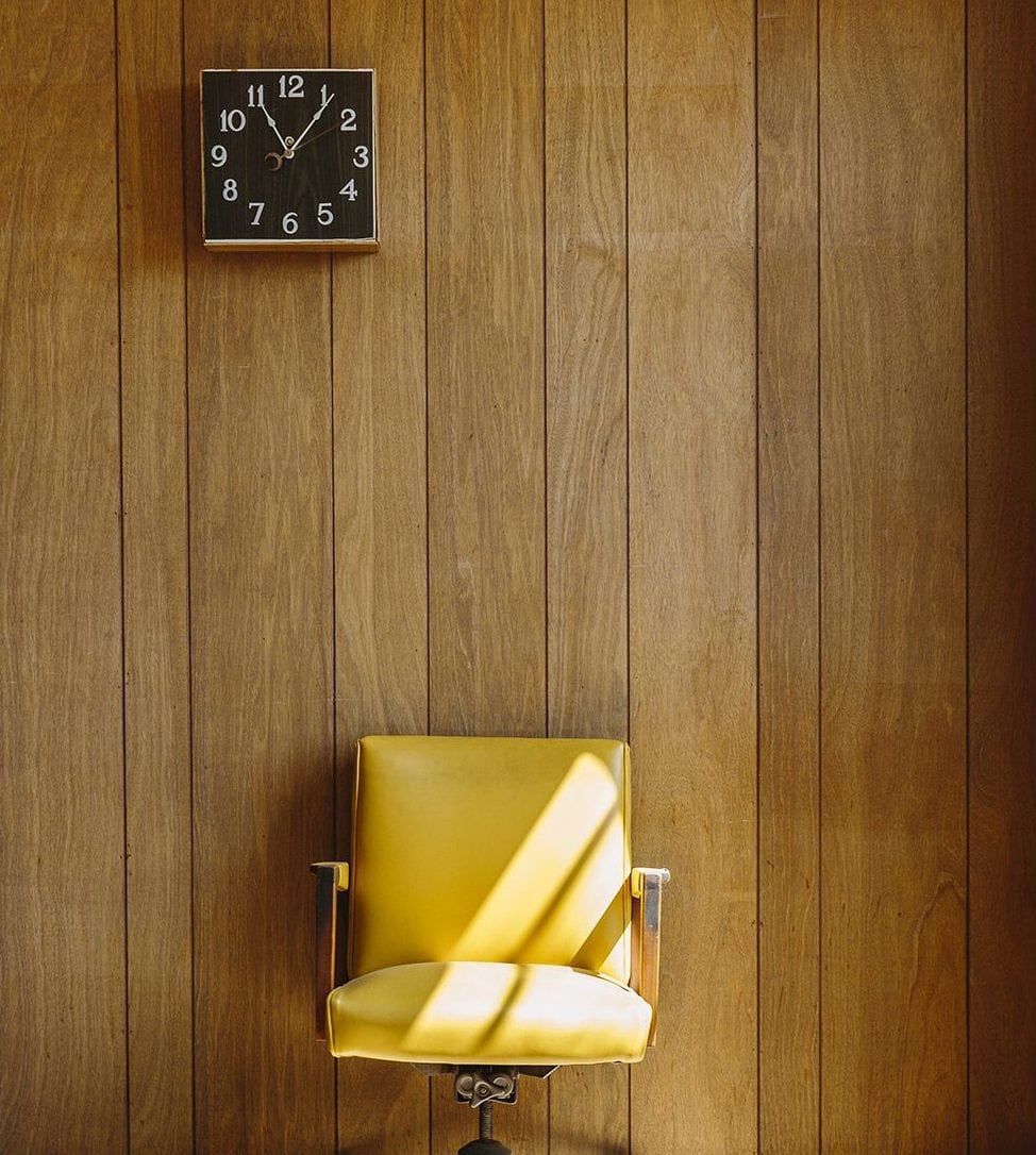 Vintage Yellow Office Chair With Wood Paneling