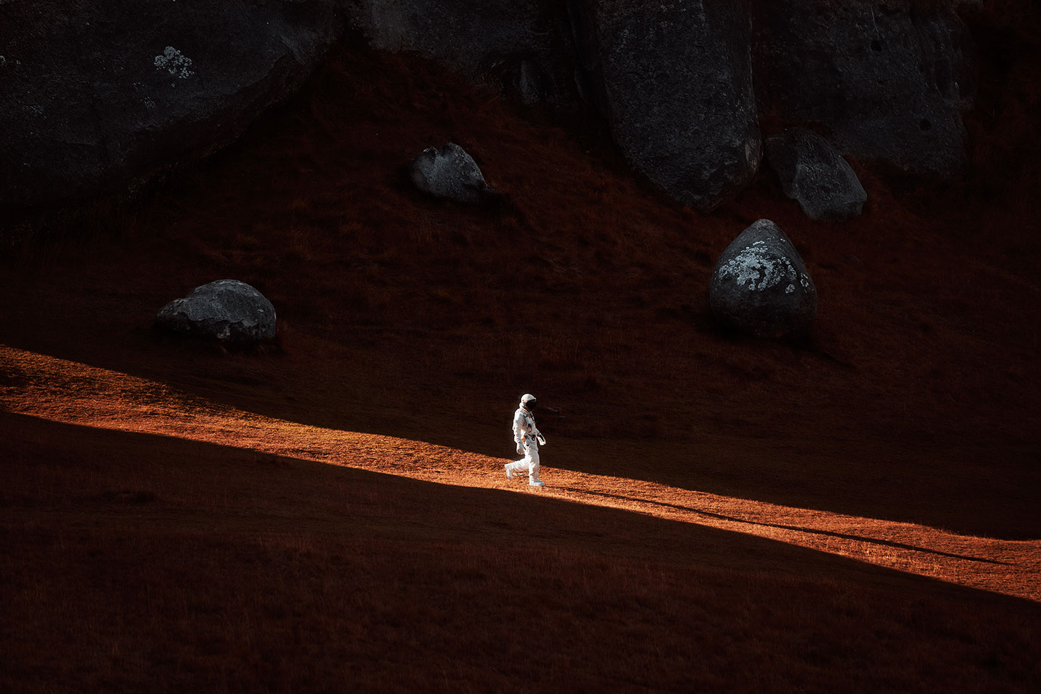 A Lone Astronaut Descends The Side Of A Mountain.