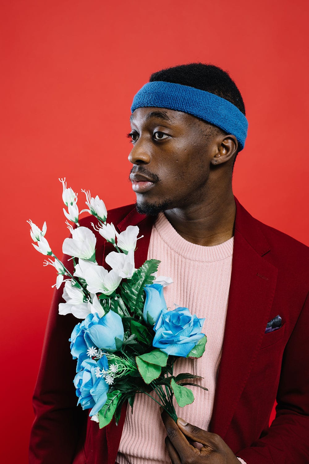 Black Man In Suit Holding Flowers