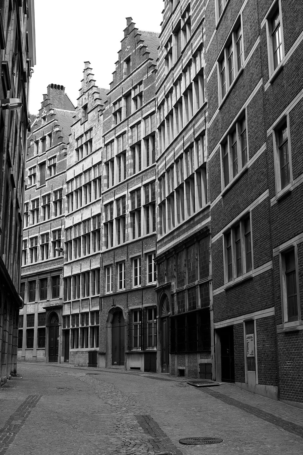Black and white image of historical houses in a beautiful old street in the center of Antwerpen, Belgium.