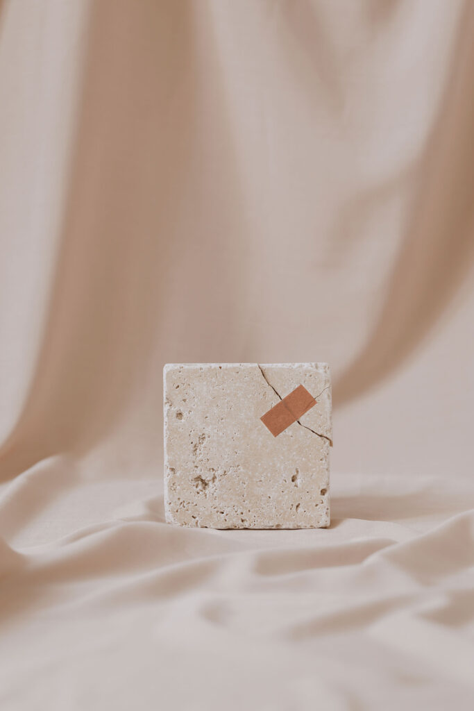 Conceptual still life with a broken tile with a piece of tape