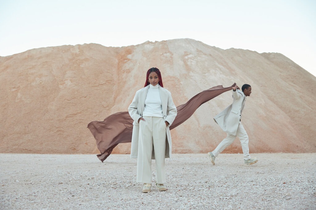 Couple Playing With A Brown Veil In Desert