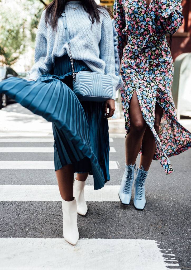 Two women walking in New York City wearing blue and white heels