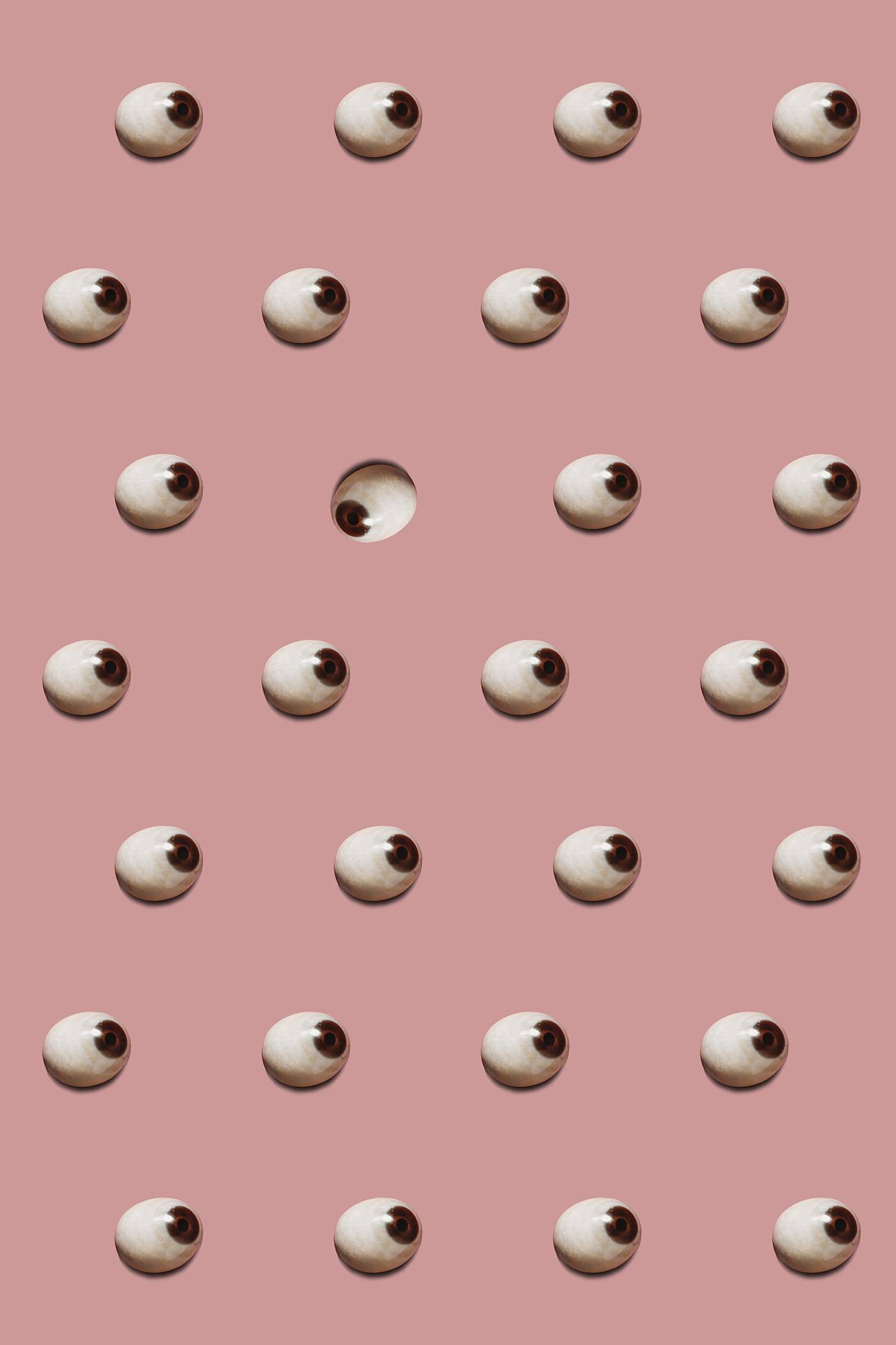 Pattern Of Eye Prosthesis repetition of eye prosthesis on pink background, one in the other direction then the other