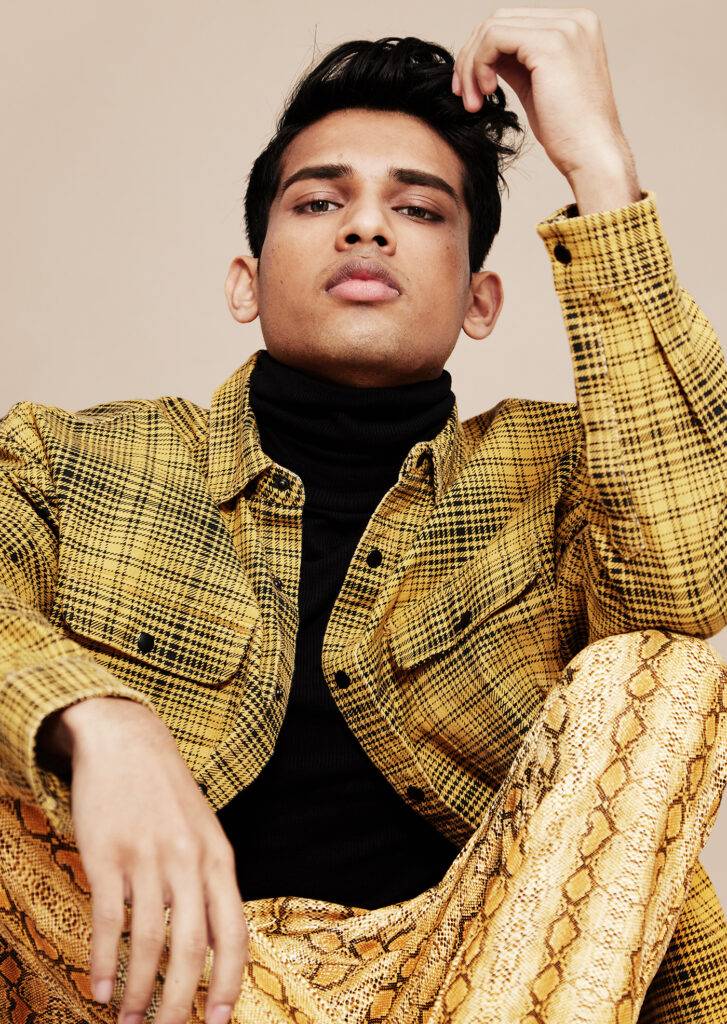Young Indian model in colourful yellow fashion clothes.