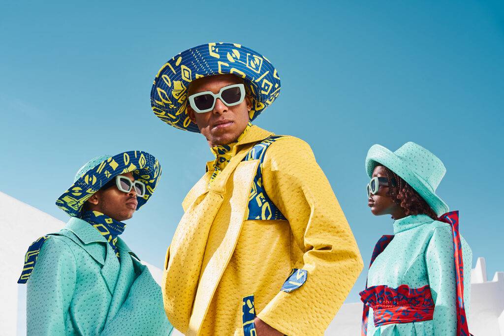 Models wearing modern South African fashion in a a white outdoor studio