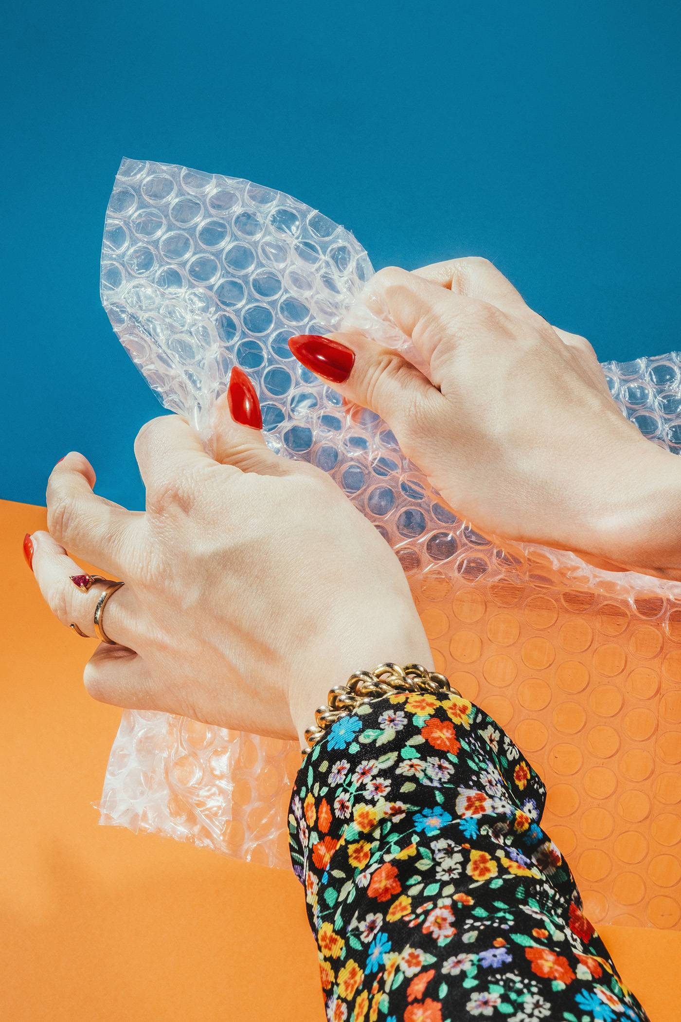 Female Hands Popping Bubbles On Bubble Wrap.