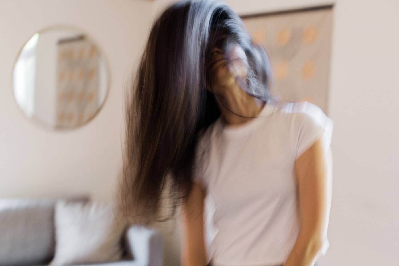 blurry photo of woman whipping hair while dancing to music