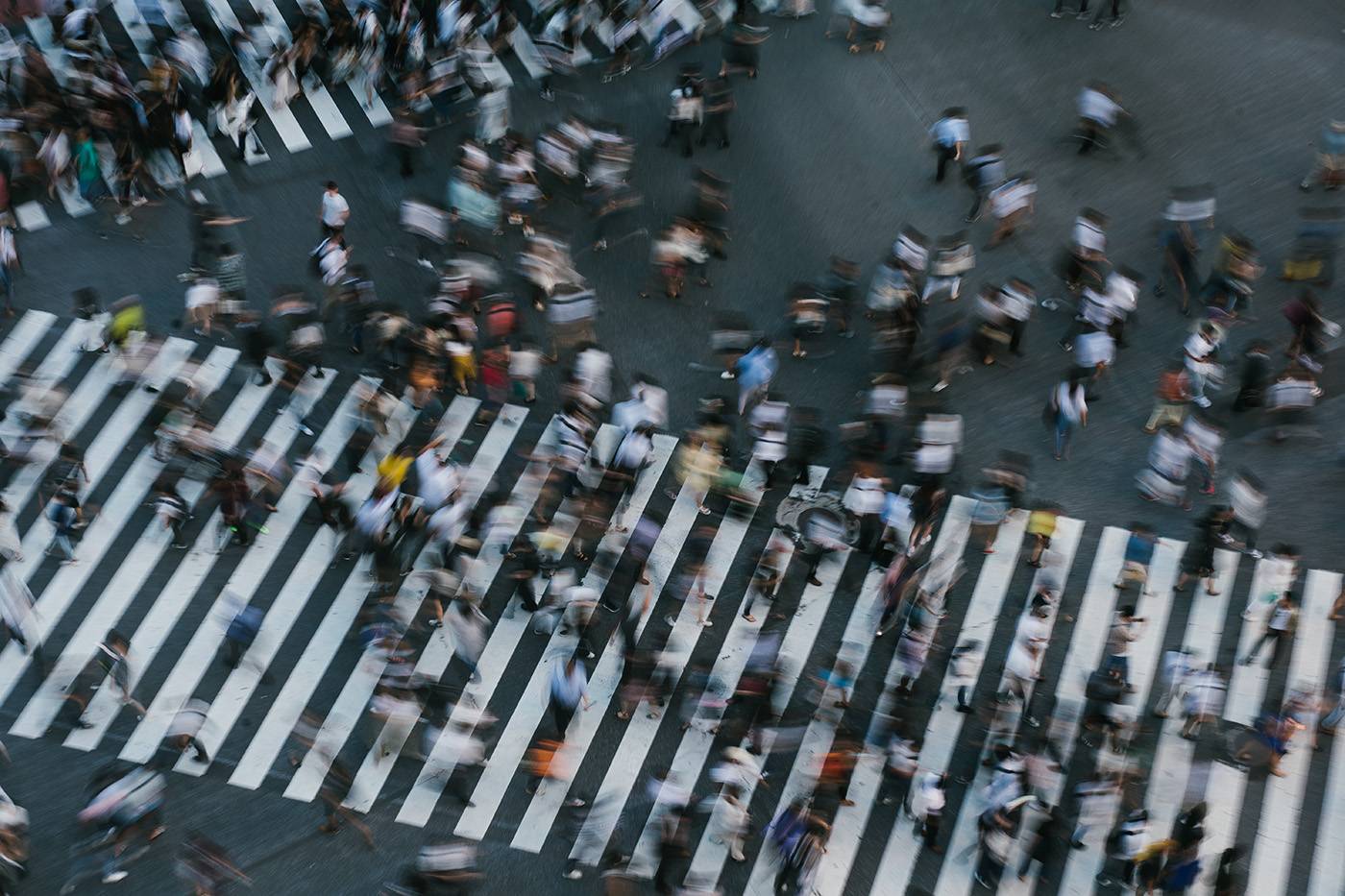 people crossing the Shibuya intersection in Tokyo Japan