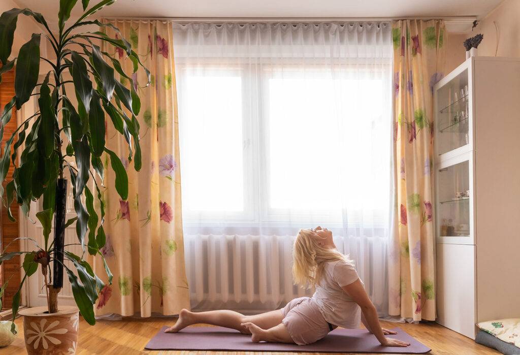 Stock Photo Of Beautiful Young Woman With A Disability Doing Yoga Exercise On Mat At Living Room.