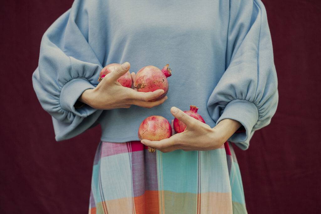 Hands holding some organic pomegranates