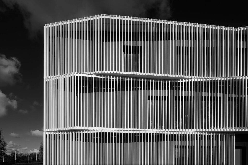 Corrugated facade of a contemporary office building. Architecture by L-arch.