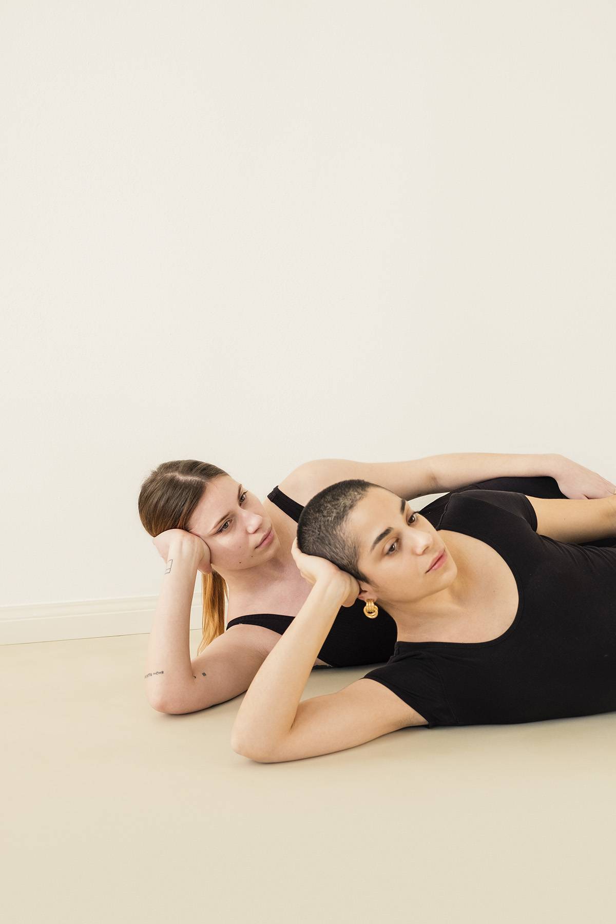 two young women lounging in yoga clothes