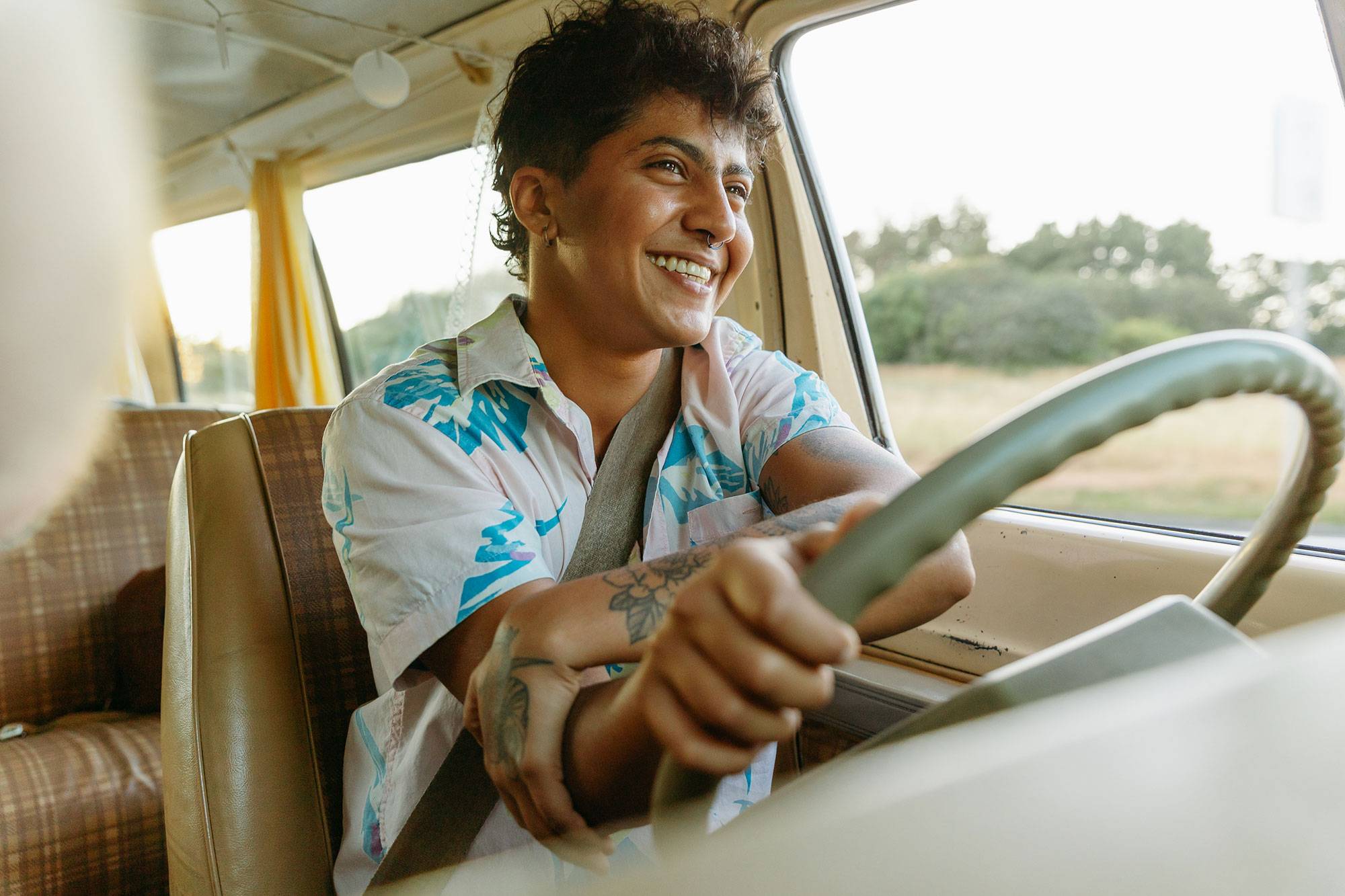 Gender-Neutral Driving Van While Smiling