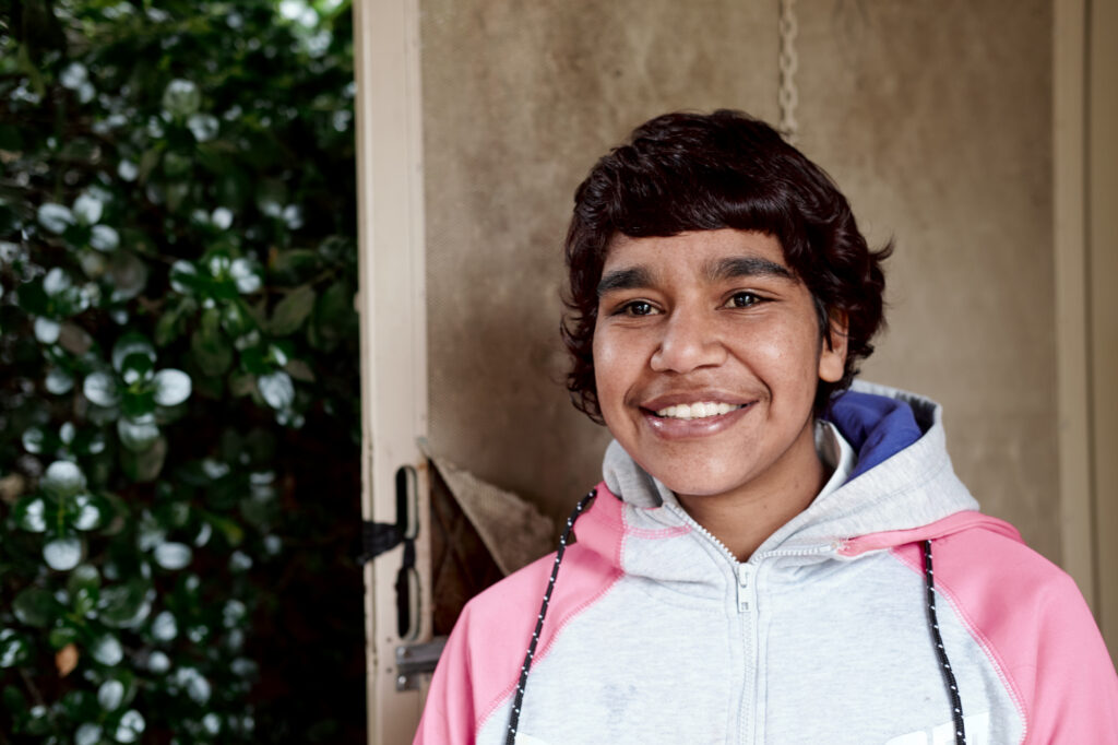 Young Aboriginal Woman At Front Door