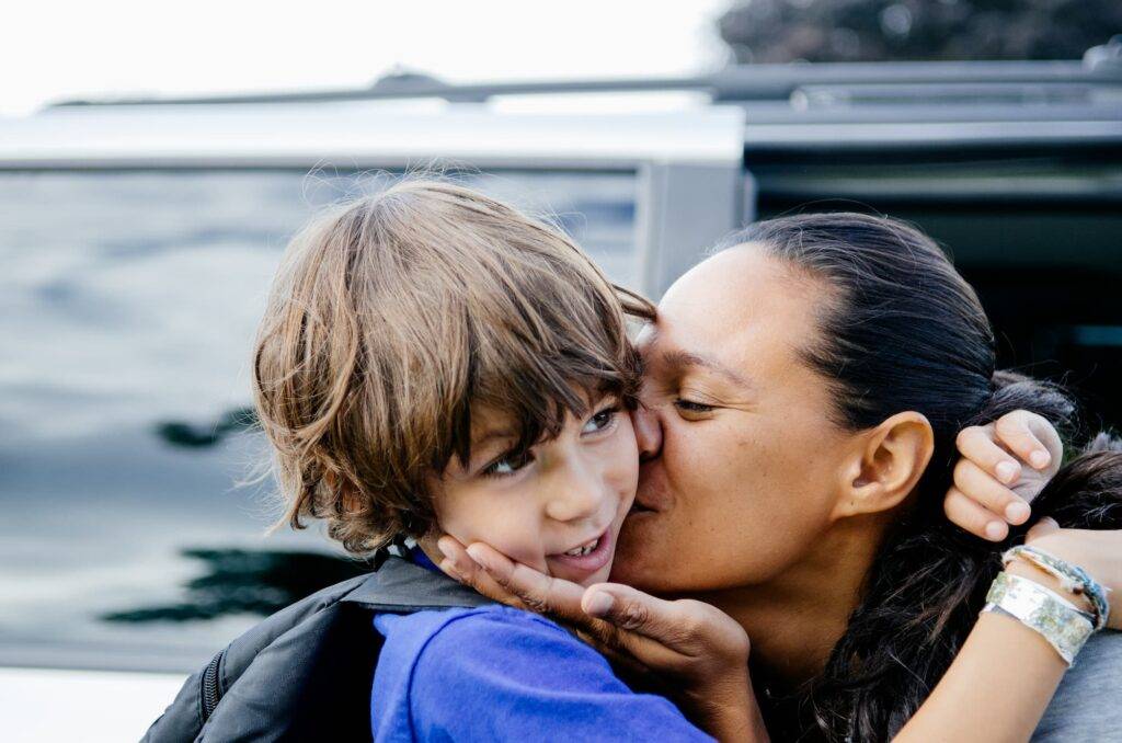 Mother Gives Son A Kiss On The First Day Of School
