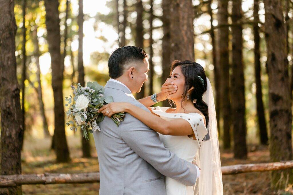 Happy Bride Laughing With Groom A bride covers her face as she laughs.