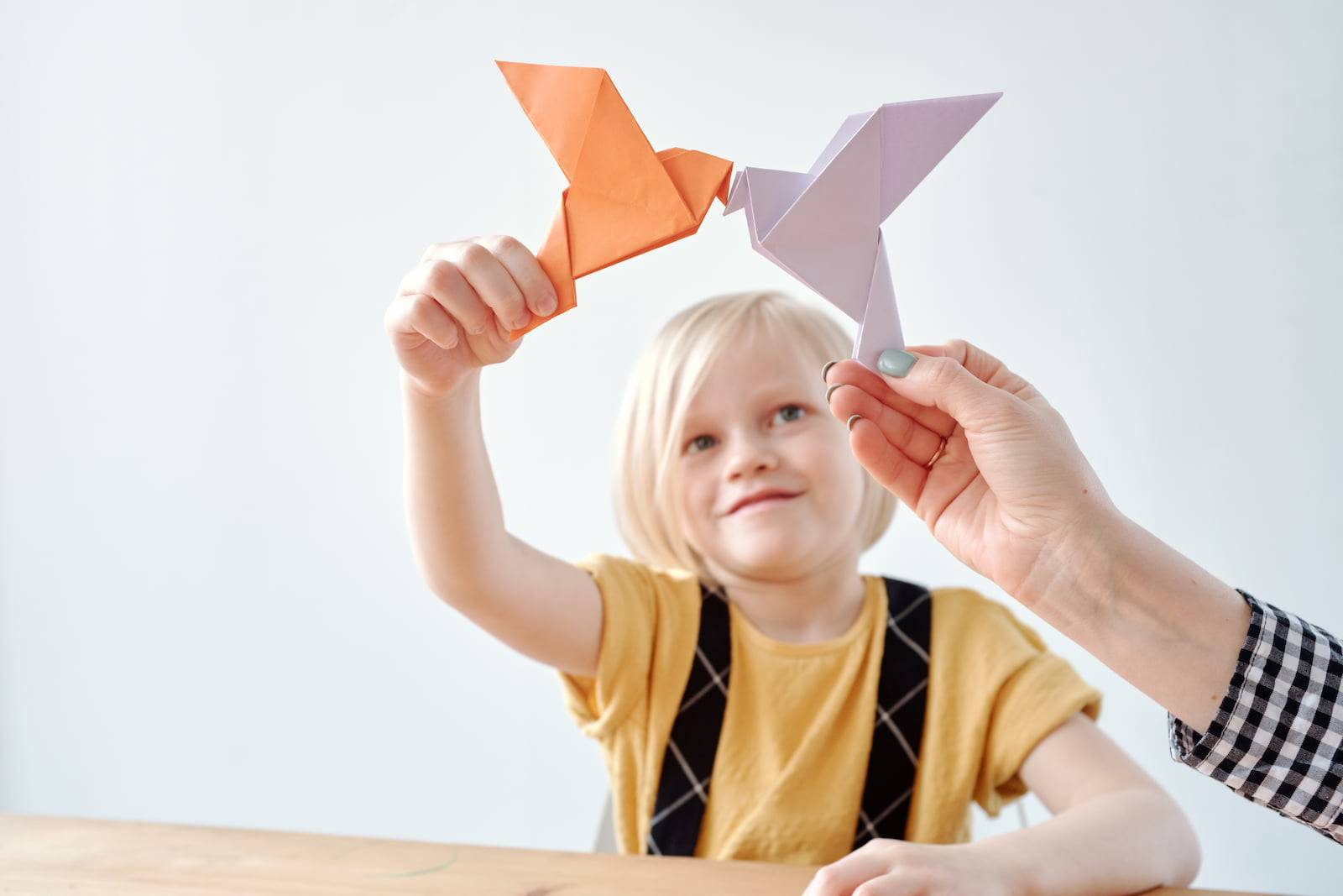 Girl playing with origami doves