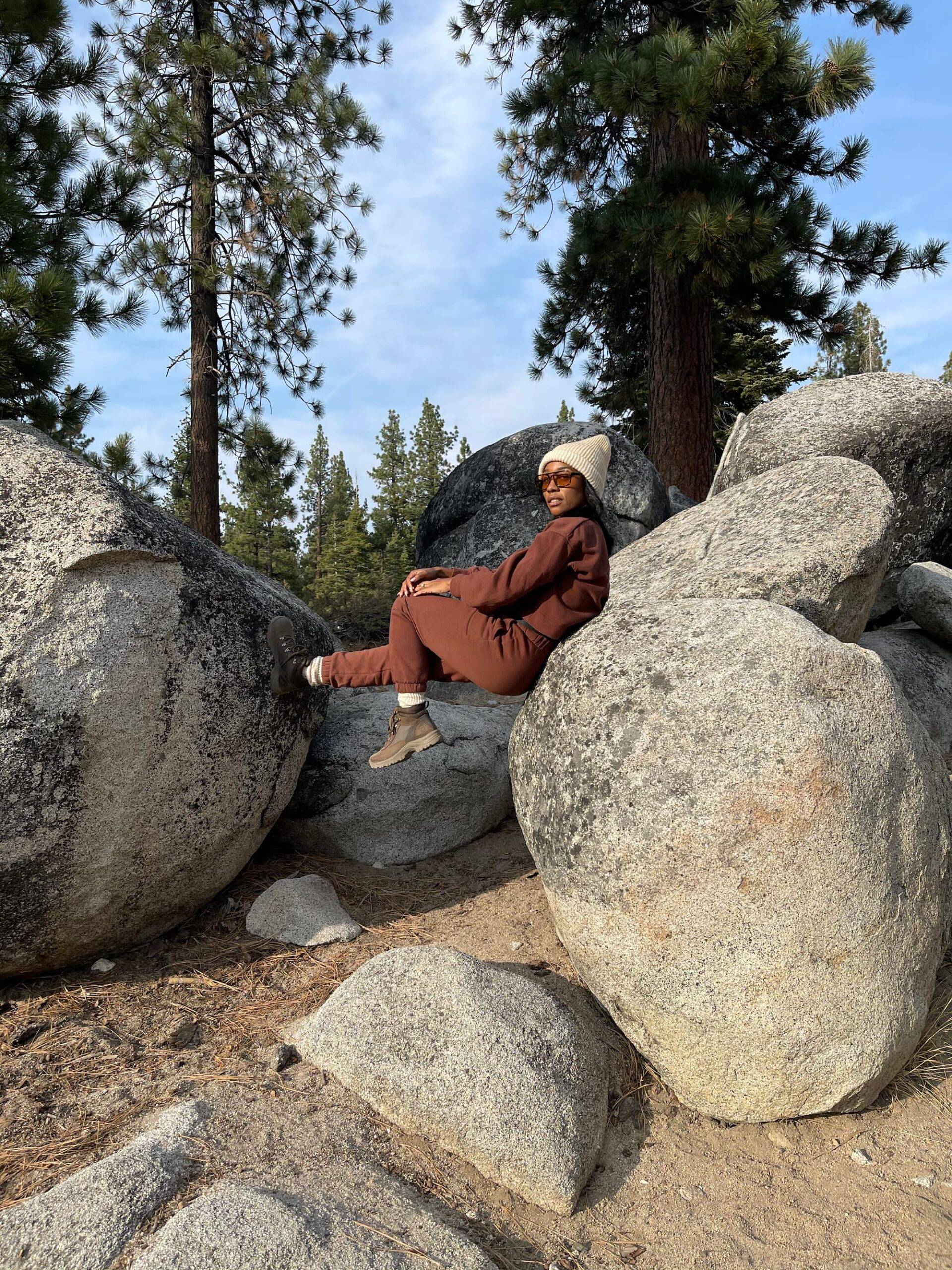 Woman sitting on giant rocks in Lake Tahoe Forest