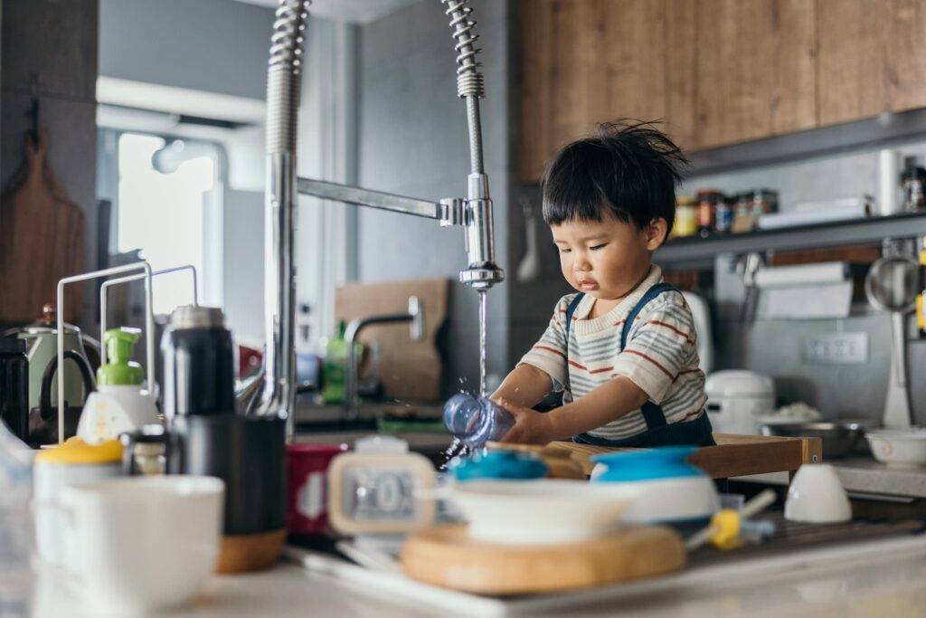 Asian Little Baby Boy Wash Bottle By Himself