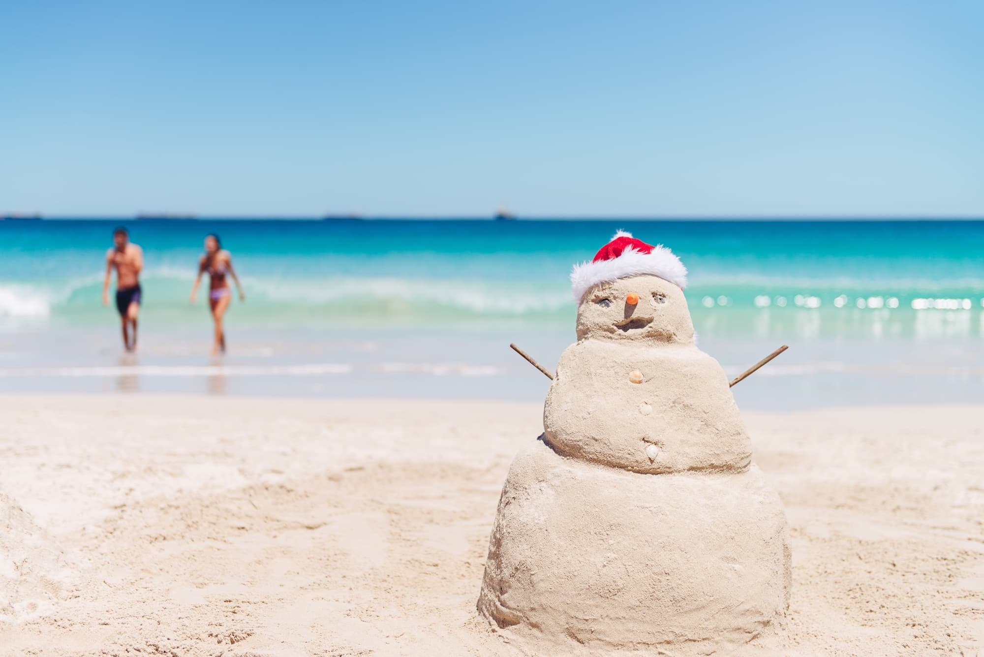 Large Smiling Sand Snowman At The Beach In Australia On Christmas Day