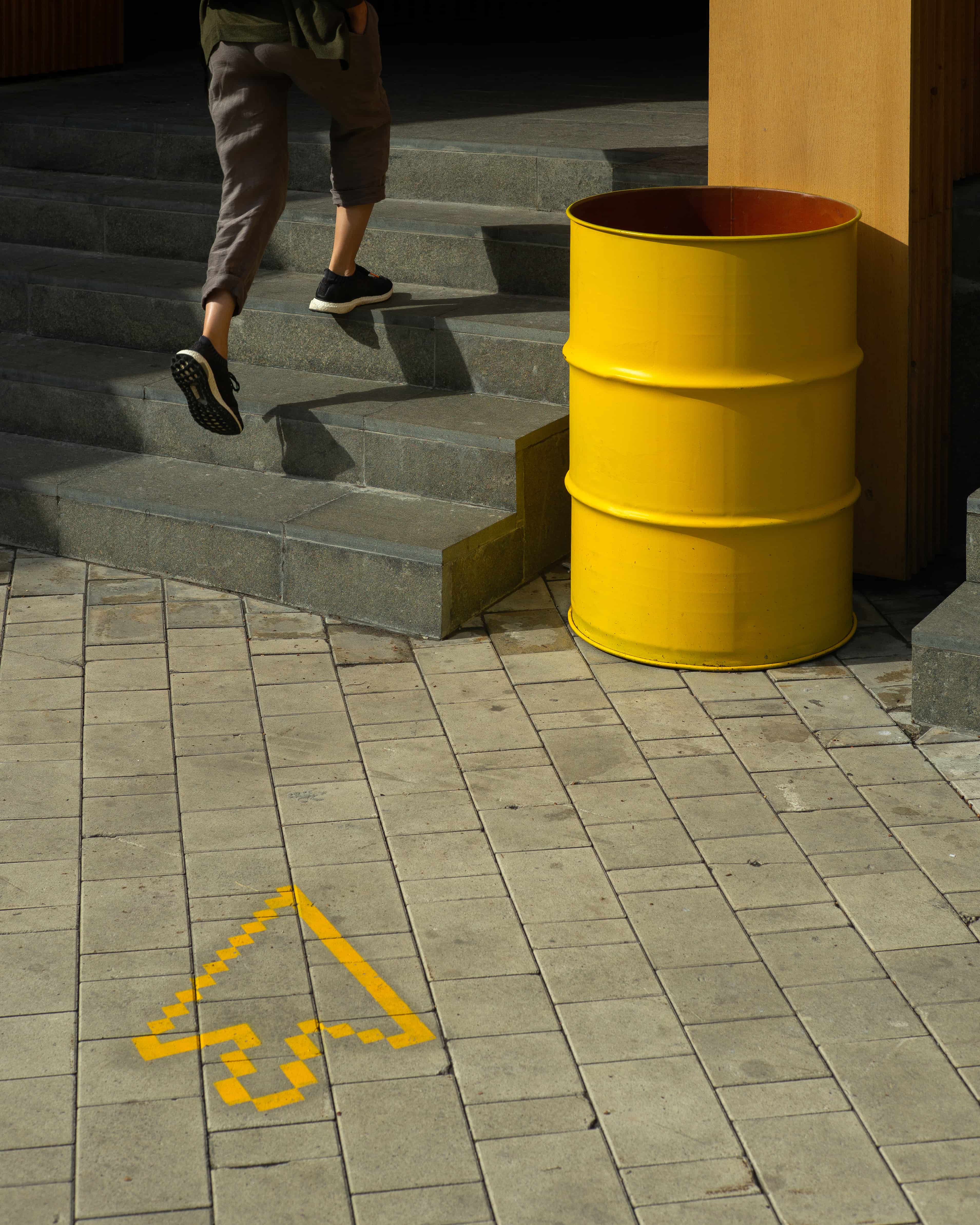 Anonymous woman running running up the stairs to urban cafe