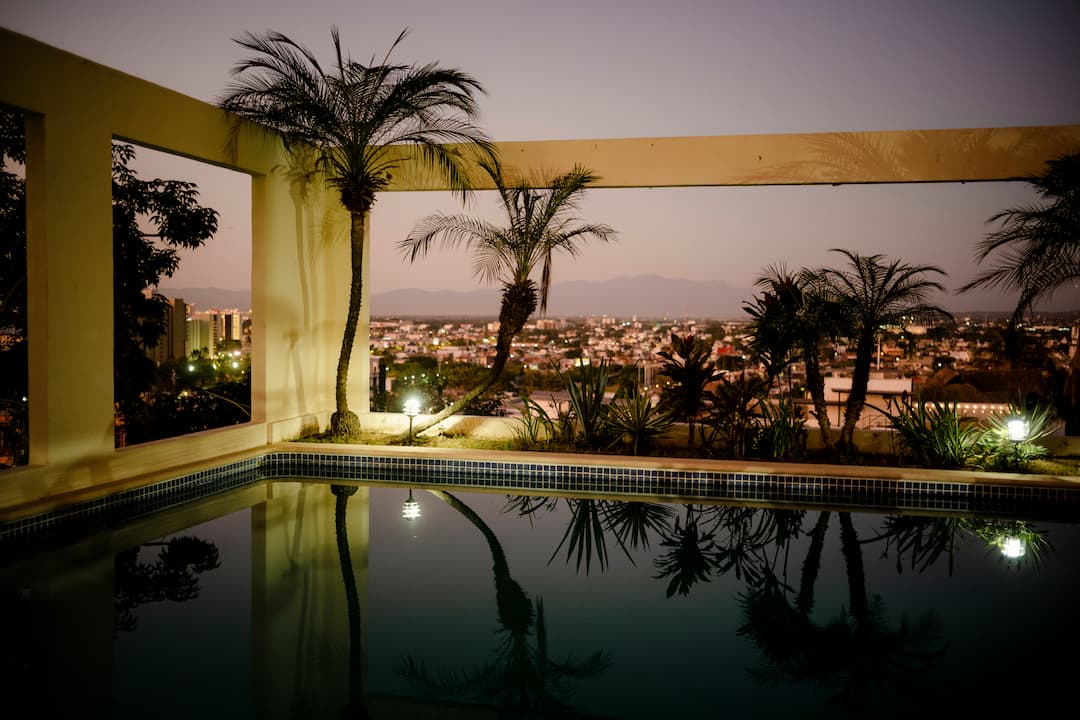 A pool surrounded by palm trees in a fishing town in Mexico.