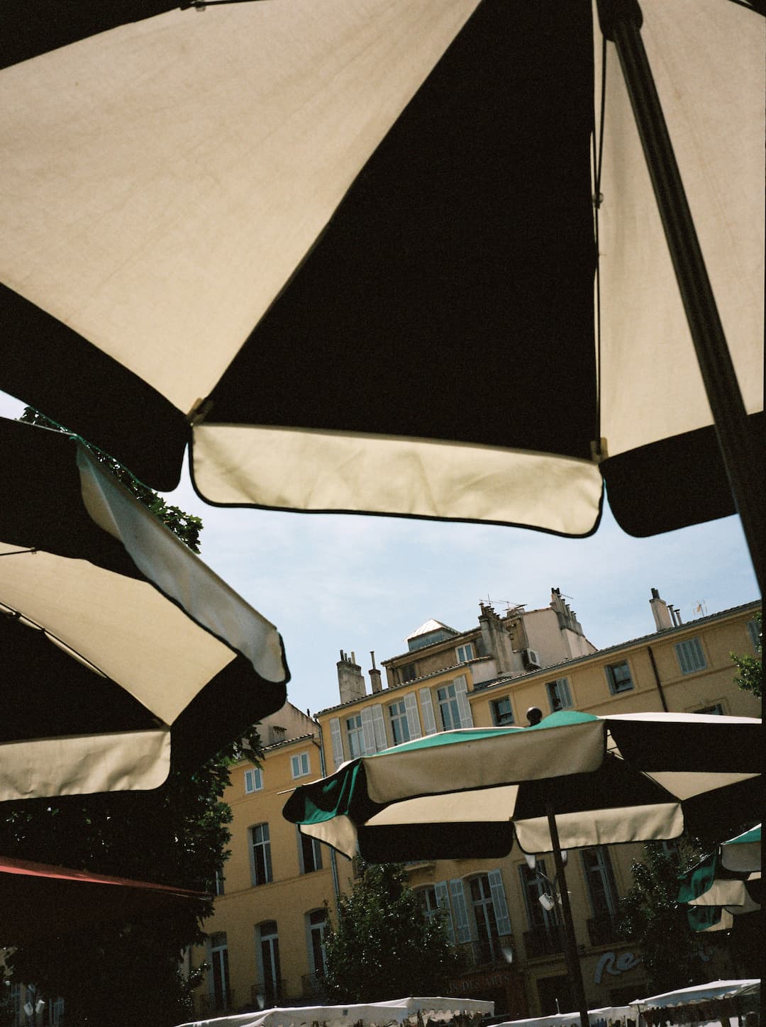 Sheltering from the summer heat under the umbrellas of a cafe while on vacation