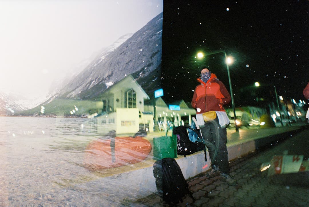 Night waiting for the bus and snowy mountain