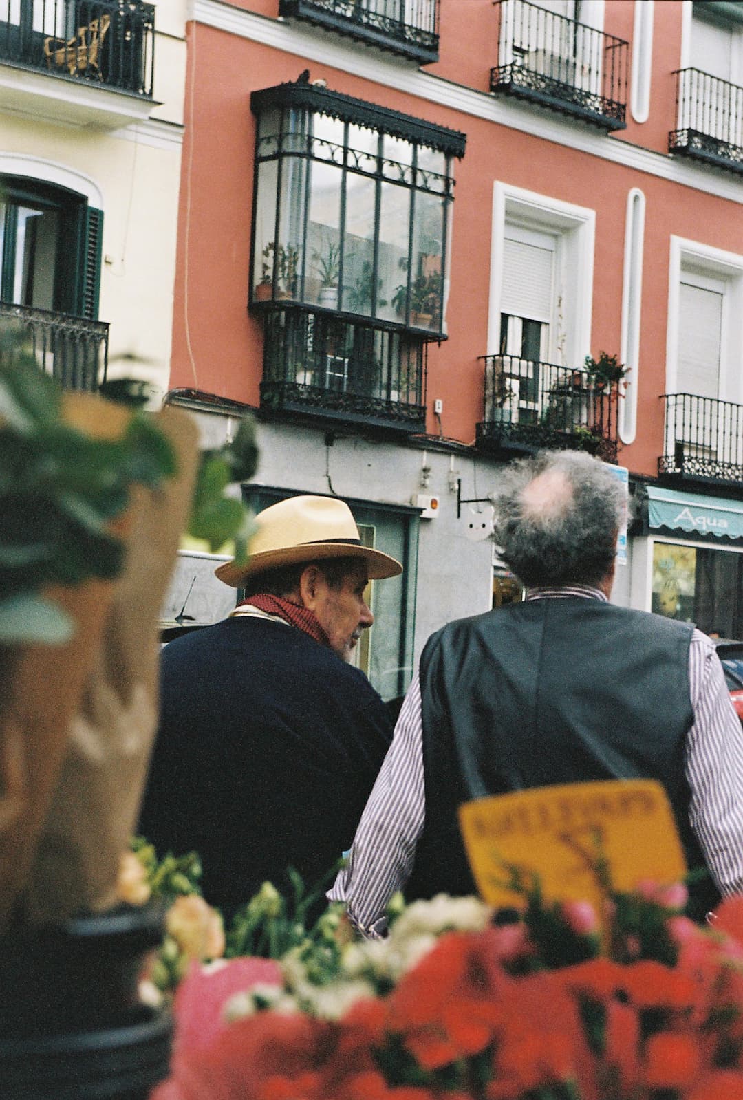 People in the street. Details of an two men resting on a flower market