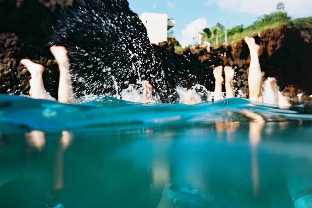 feet sticking up out of ocean