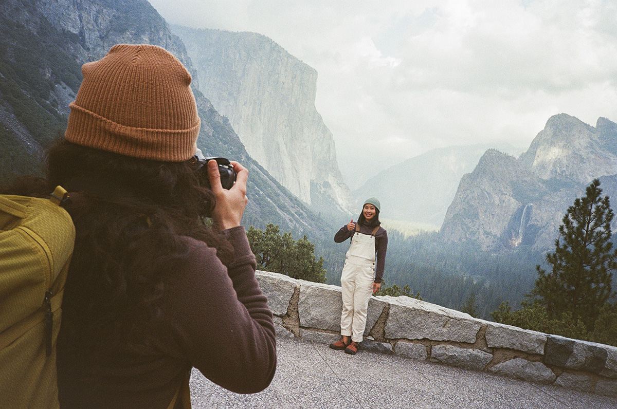 Like Save Share Comp Similar Admin Christine La's Avatar Christine La San Francisco Bay Area/Sacramento Taking picture Yosemite National Park Roadtrip vacation tourist exploring and sightseeing Yosemite National Park. Diverse friends taking photo at tunnel view in the fall winter season with cloudy overcast skies. Young woman holding camera taking photo of friend posing for portrait with thumbs up. Olympus XA3 35 film camera. USA travel concept