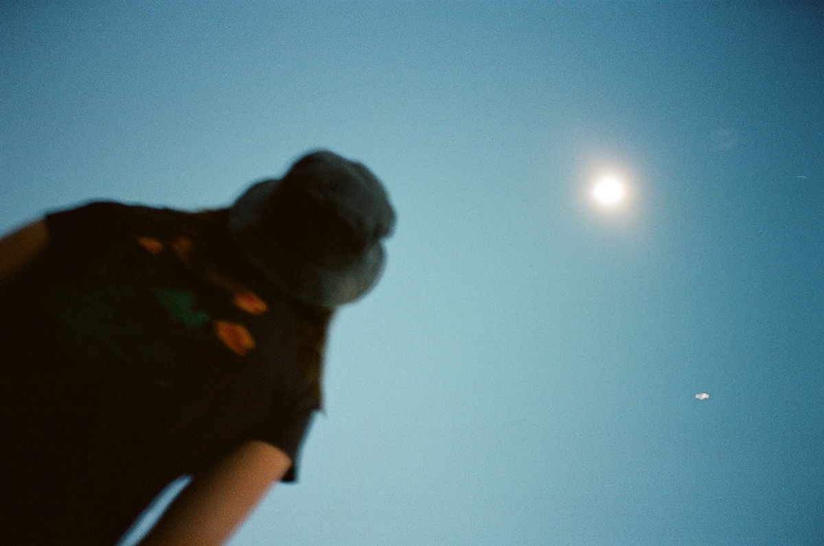 Before and After: Total Solar Eclipse 35mm Film 35mm film photo of back view of woman watching and looking up at the total solar eclipse 2024 from Glen Rose, Texas.